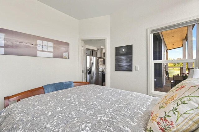 bedroom featuring stainless steel fridge