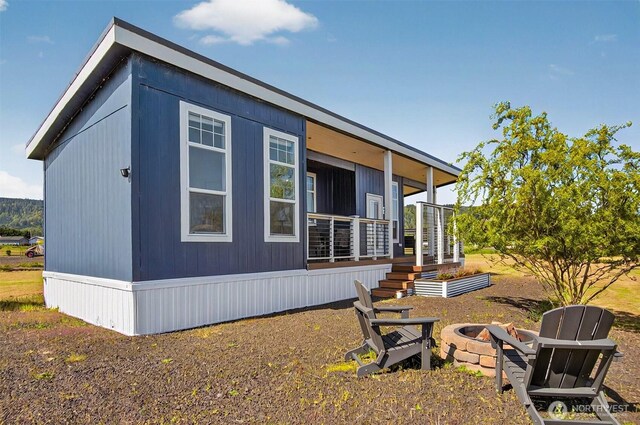 view of property exterior featuring a fire pit and stairway