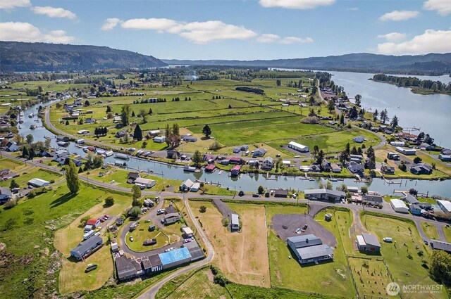 birds eye view of property with a water and mountain view