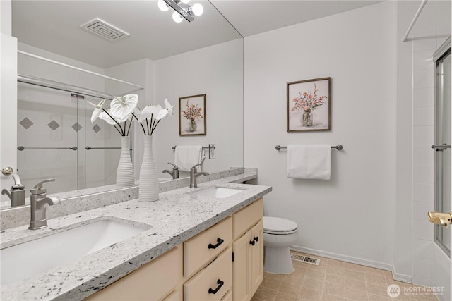 bathroom with a shower with door, baseboards, toilet, and double vanity