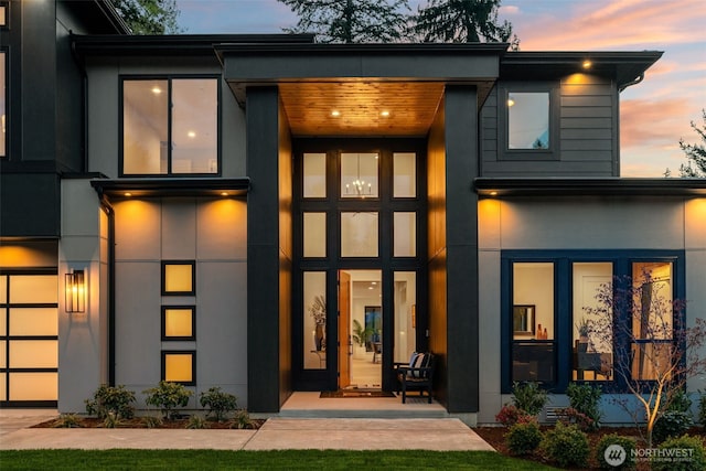 rear view of property featuring stucco siding and covered porch