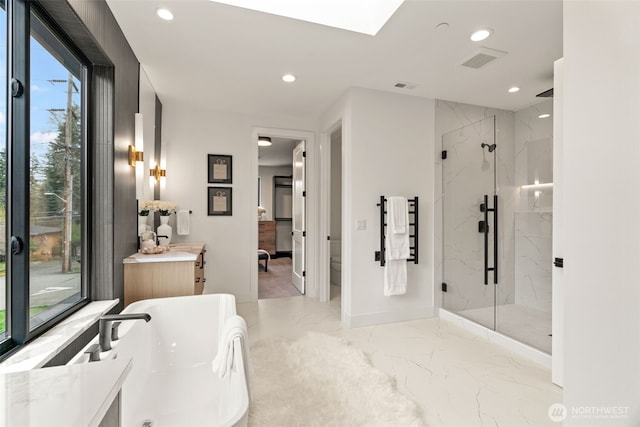 full bathroom with recessed lighting, a freestanding bath, a marble finish shower, and marble finish floor
