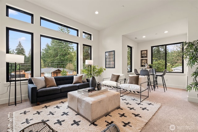 carpeted living room with plenty of natural light, recessed lighting, and baseboards