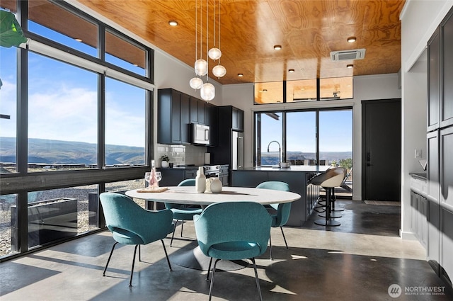 23654 Gorge View Loop NW, Quincy, WA 98848 - dining area with visible vents, recessed lighting, wood ceiling, and concrete flooring