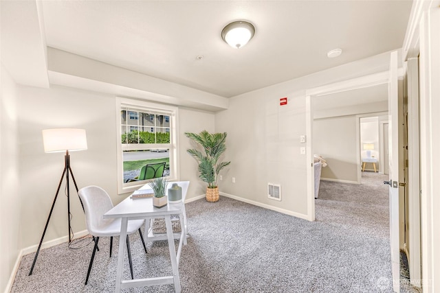 carpeted home office featuring baseboards and visible vents