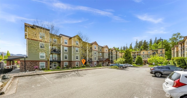 exterior space with a residential view, sidewalks, and curbs