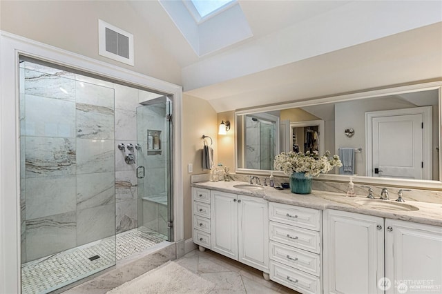 full bathroom featuring visible vents, a sink, marble finish floor, and a stall shower