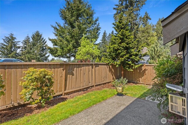 fenced backyard with a patio area