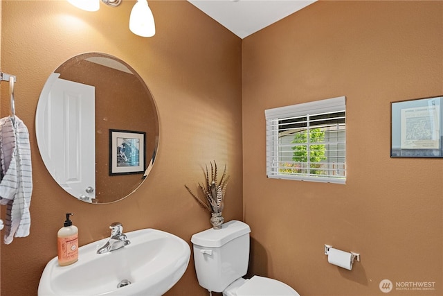 half bathroom with a sink and toilet