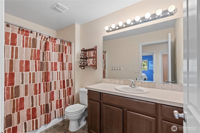 full bathroom with toilet, vanity, and a shower with shower curtain
