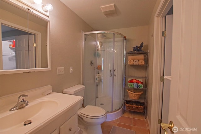 8903 Crescent Bar Rd NW Unit 107, Quincy, WA 98848 - full bathroom with vanity, tile patterned flooring, toilet, and a shower stall