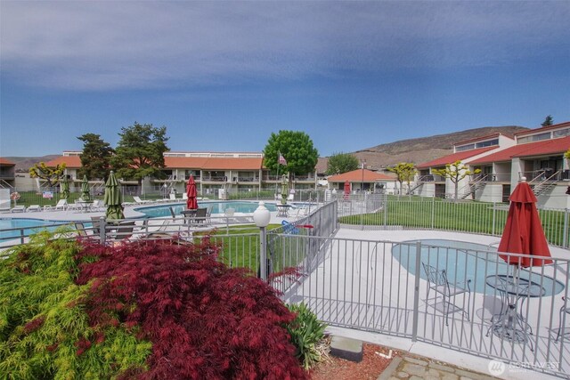 8903 Crescent Bar Rd NW Unit 107, Quincy, WA 98848 - exterior space with fence, a mountain view, and a residential view