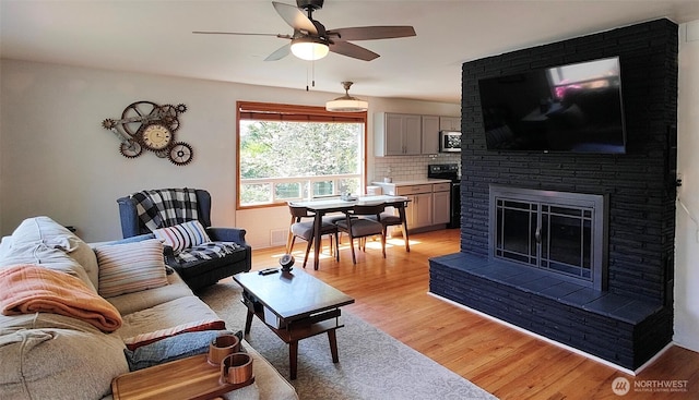 11515 7th Ave NE, Seattle, WA 98125 - living area with a fireplace, a ceiling fan, light wood-style flooring, and visible vents