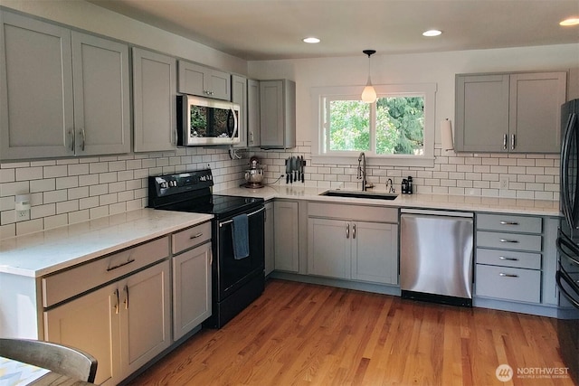 11515 7th Ave NE, Seattle, WA 98125 - kitchen with light countertops, a sink, gray cabinets, and stainless steel appliances