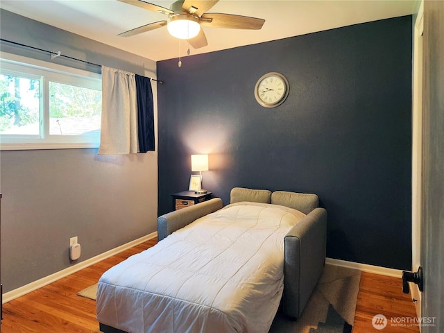 11515 7th Ave NE, Seattle, WA 98125 - bedroom featuring a ceiling fan, baseboards, and wood finished floors