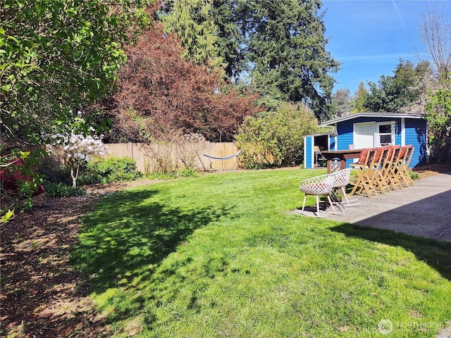 11515 7th Ave NE, Seattle, WA 98125 - view of yard featuring an outdoor structure, fence, and a patio