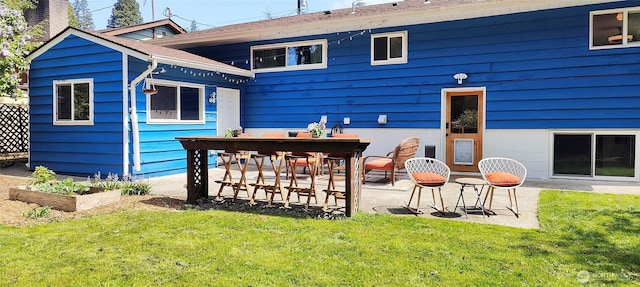 11515 7th Ave NE, Seattle, WA 98125 - back of house featuring a lawn, a patio area, a garden, and a chimney