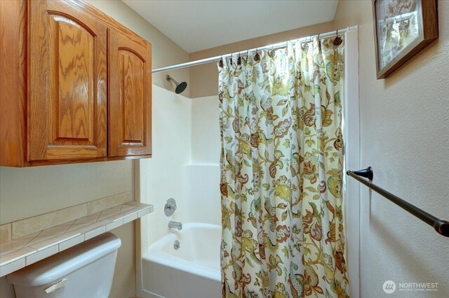 full bath featuring toilet and shower / bathtub combination with curtain