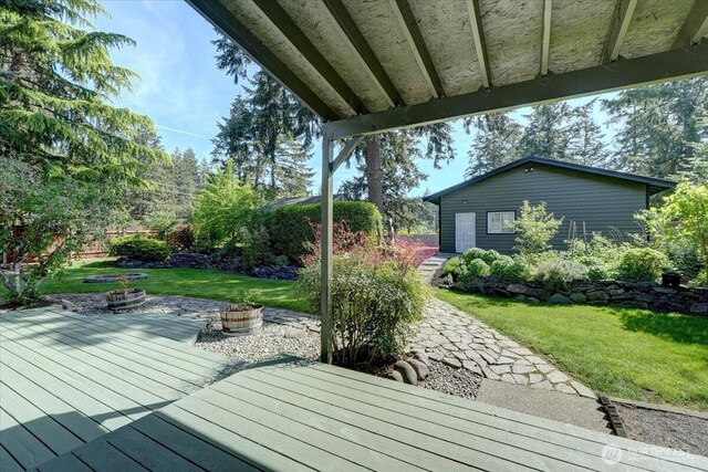 wooden deck with a lawn