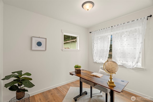 office area with baseboards and light wood-style flooring