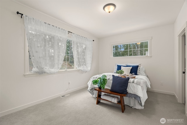 bedroom with baseboards, carpet flooring, and visible vents
