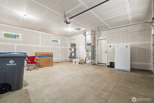 garage featuring gas water heater, a garage door opener, and freestanding refrigerator
