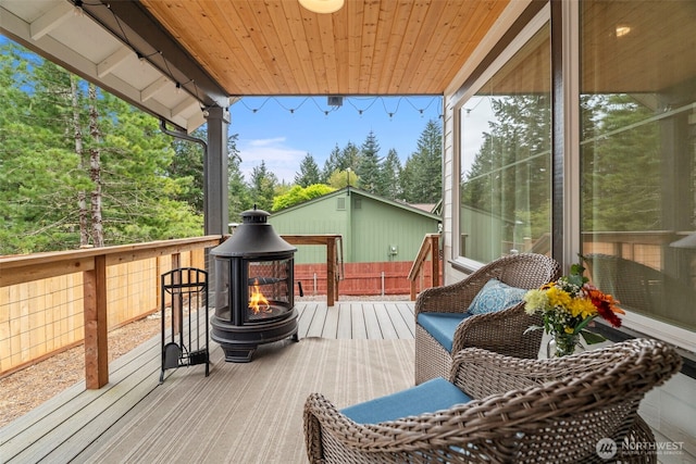 wooden deck featuring a fire pit