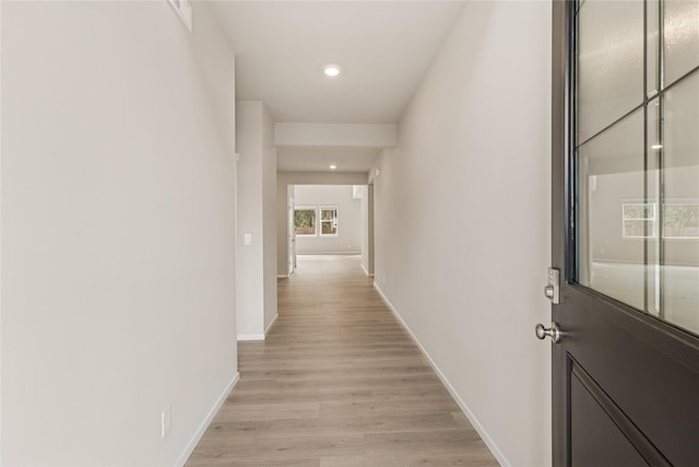 hall with baseboards, recessed lighting, and light wood-type flooring