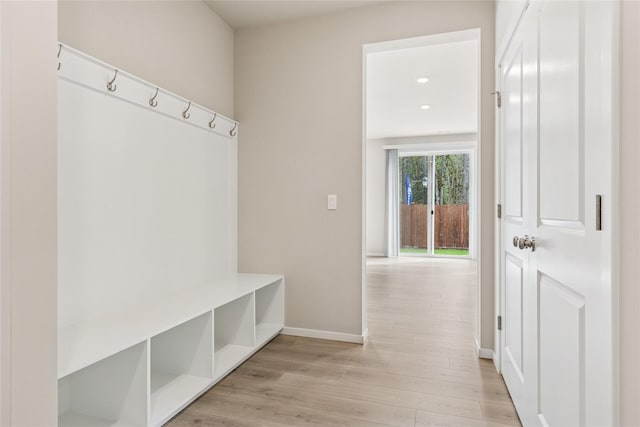 mudroom with baseboards and light wood-type flooring
