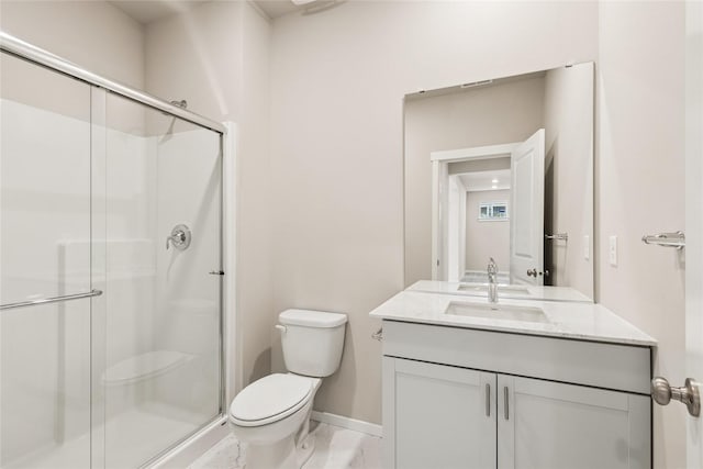 bathroom featuring baseboards, vanity, toilet, and a shower stall