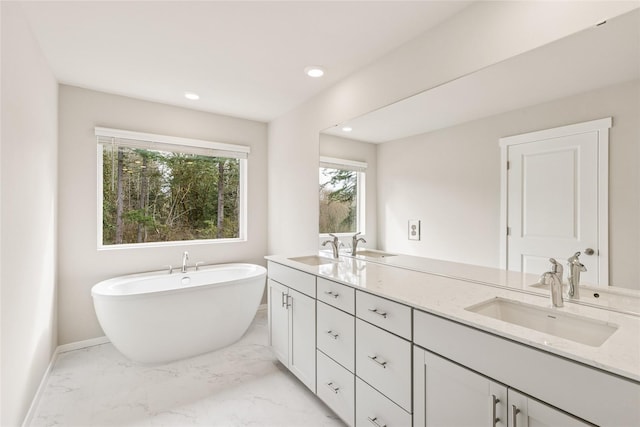 bathroom with baseboards, a sink, and marble finish floor