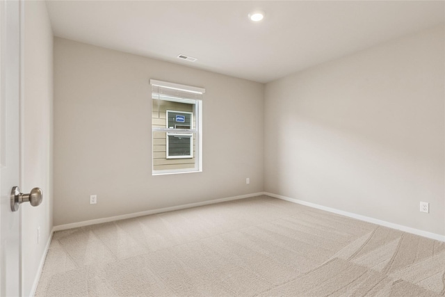 empty room featuring carpet flooring, baseboards, and visible vents