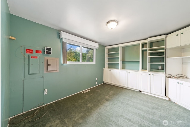 interior space featuring baseboards, visible vents, and carpet