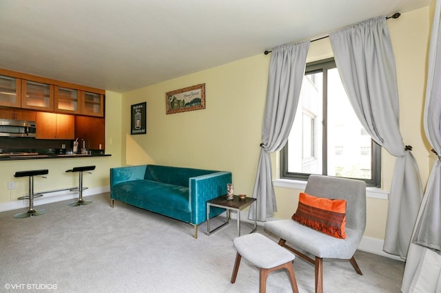 sitting room with a healthy amount of sunlight, baseboards, and carpet