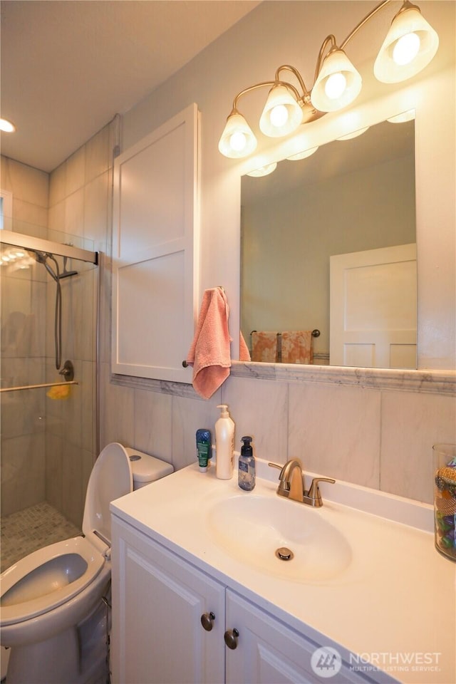 full bath featuring vanity, a stall shower, and toilet