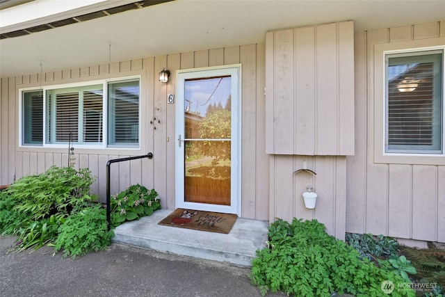 doorway to property featuring board and batten siding