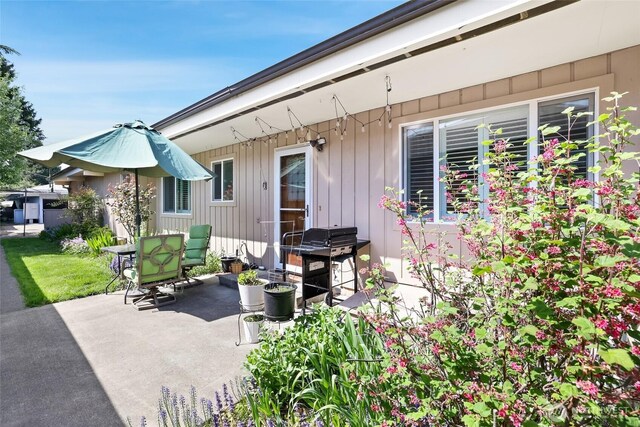 view of patio / terrace featuring outdoor dining space and a grill