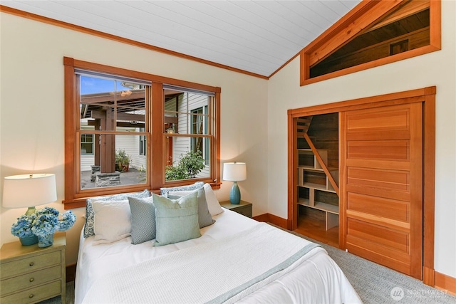 bedroom featuring crown molding, baseboards, and vaulted ceiling