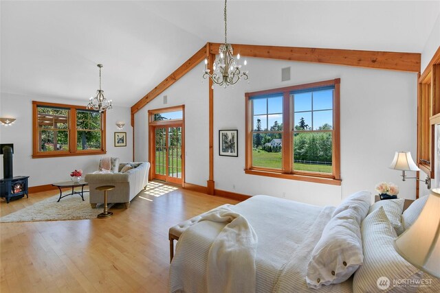 bedroom with a wood stove, a chandelier, access to exterior, vaulted ceiling with beams, and wood finished floors
