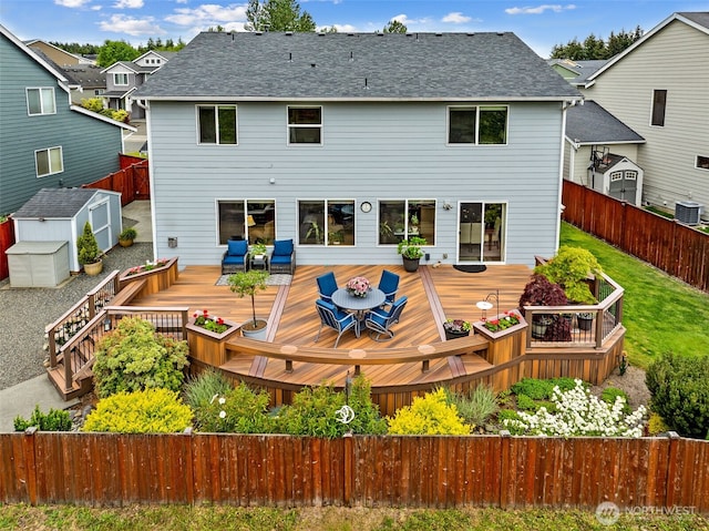 20011 195th Ave E, Orting, WA 98360 - rear view of house with outdoor dining area, a fenced backyard, cooling unit, a wooden deck, and roof with shingles
