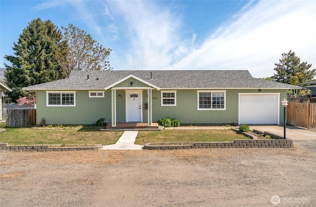 ranch-style house with a garage, a front lawn, fence, a shingled roof, and concrete driveway