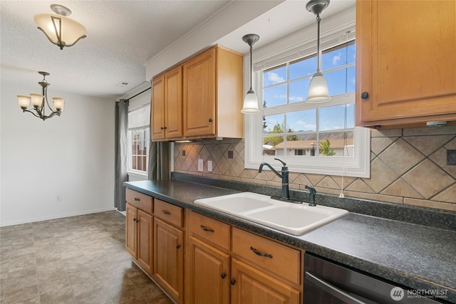 kitchen featuring backsplash, dark countertops, a sink, and dishwasher