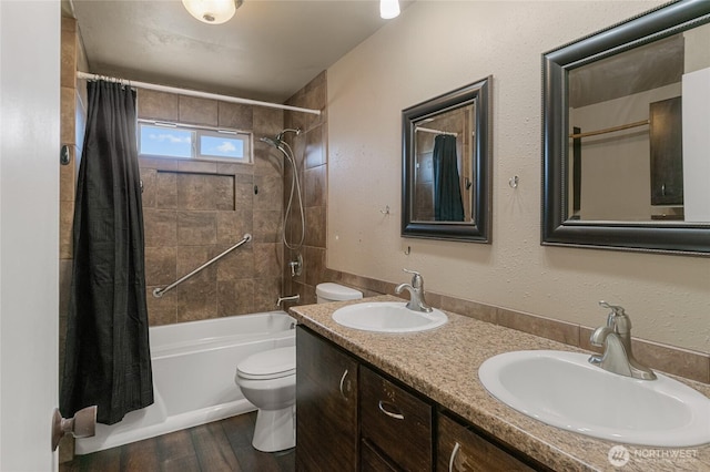 full bath featuring a sink, toilet, wood finished floors, and shower / bath combination with curtain