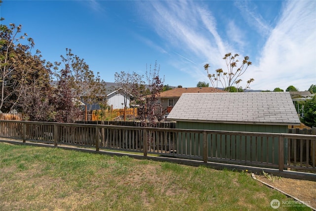 view of yard featuring a fenced backyard and a residential view