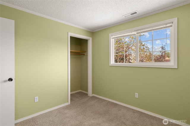 unfurnished bedroom featuring visible vents, a closet, baseboards, a textured ceiling, and carpet flooring