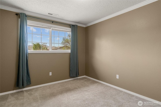spare room with crown molding, carpet floors, a textured ceiling, baseboards, and visible vents