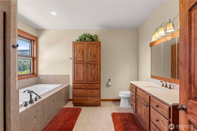 full bath with vanity, a garden tub, toilet, tile patterned floors, and baseboards