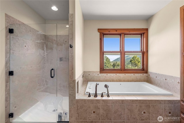 bathroom with a bath, a stall shower, and recessed lighting