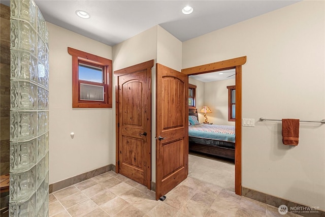bathroom with ensuite bath, baseboards, recessed lighting, and walk in shower