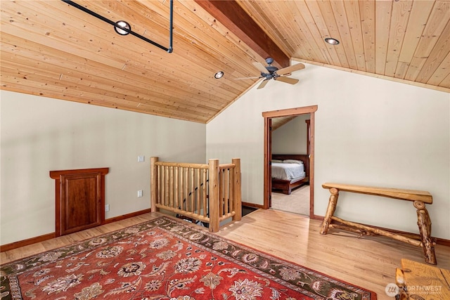 additional living space with wood finished floors, wooden ceiling, baseboards, and ceiling fan